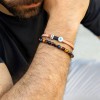 Δερμάτινο ανδρικό βραχιόλι με μάτι από σμάλτο Δερμάτινο ανδρικό βραχιόλι με επάργυρα μεταλλικά στοιχεία και μάτι από σμάλτο