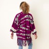Knitted poncho with sleeves and fringes