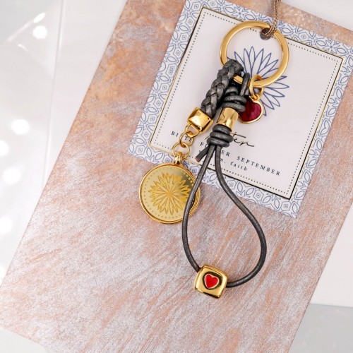 Women's keychain with with birth flower, leather and gold-plated parts