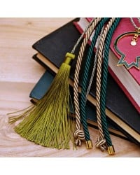 Lucky charm with enamel pomegranate and satin cords Lucky charm with enamel pomegranate and satin cords