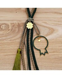 Lucky charm with enamel pomegranate and satin cords Lucky charm with enamel pomegranate and satin cords