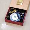 Handmade lucky keyring Evil Eye with meander pattern in a gift box