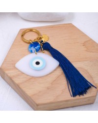 Handmade key-chain with plexiglass evil eye and silk tassel Handmade key-chain with plexiglass evil eye, gold-plated parts and silk tassel