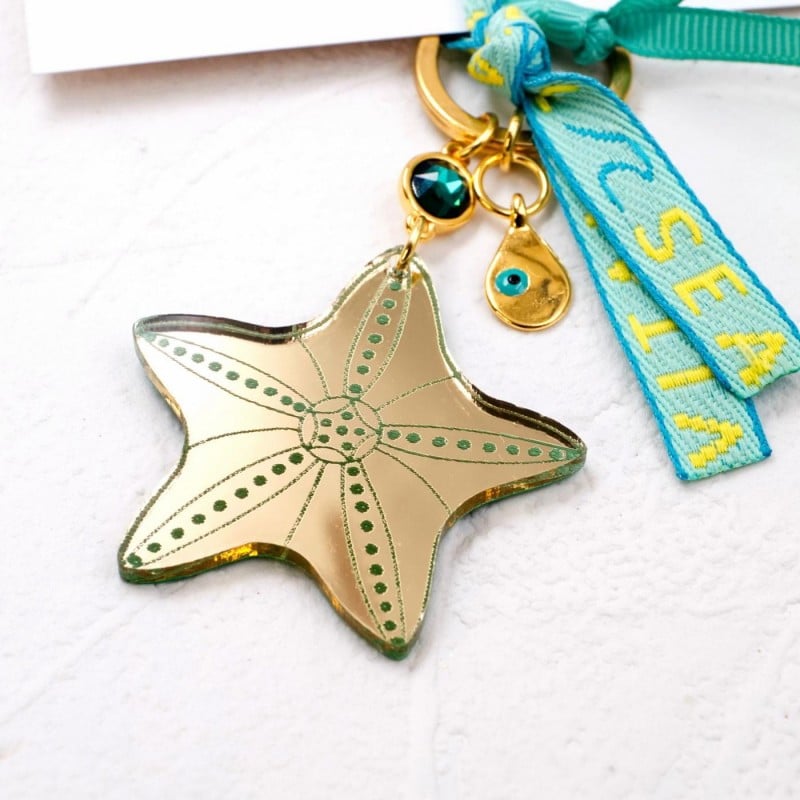 Handmade key-chain with plexiglass starfish and evil eye Handmade key-chain with plexiglass sea shell and evil eye drop