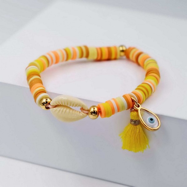 Handmade elastic bracelet with gold-plated metal parts and cowrie shell