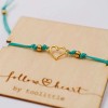 Handmade macrame bracelet with gold-plated heart and wooden card