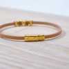 Handmade leather bracelet with gold-plated metal parts and enamel