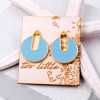Stud earrings with enamel in gold-plating on wooden engraved card 