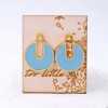 Stud earrings with enamel in gold-plating on wooden engraved card 