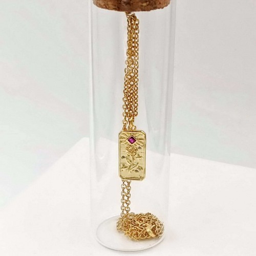 Short gold-plated necklace with zircon in a glass bottle