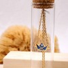 Handmade necklace in a bottle with gold-plated parts and enamel