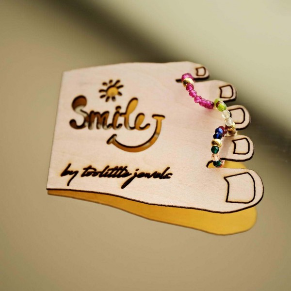 Set of 3 elastic toe rings on a wooden card with glass beads and gold-plated parts