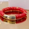 Handmade elastic bracelet with resin and gold-plated metal parts 