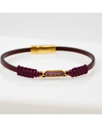 Handmade leather bracelet with gold-plated metal parts and glittered enamel Handmade leather bracelet with gold-plated metal parts and glittered enamel