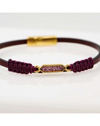 Handmade leather bracelet with gold-plated metal parts and glittered enamel Handmade leather bracelet with gold-plated metal parts and glittered enamel