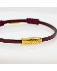 Handmade leather bracelet with gold-plated metal parts and glittered enamel Handmade leather bracelet with gold-plated metal parts and glittered enamel