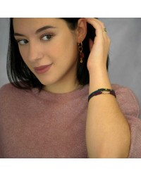 Handmade leather bracelet with gold-plated metal parts and glittered enamel Handmade leather bracelet with gold-plated metal parts and glittered enamel