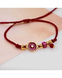 Makrame bracelet with gold-plated enamelled parts Handmade makrame bracelet made of high quality cord with gold-plated enamelled parts