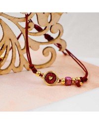 Makrame bracelet with gold-plated enamelled parts Handmade makrame bracelet made of high quality cord with gold-plated enamelled parts