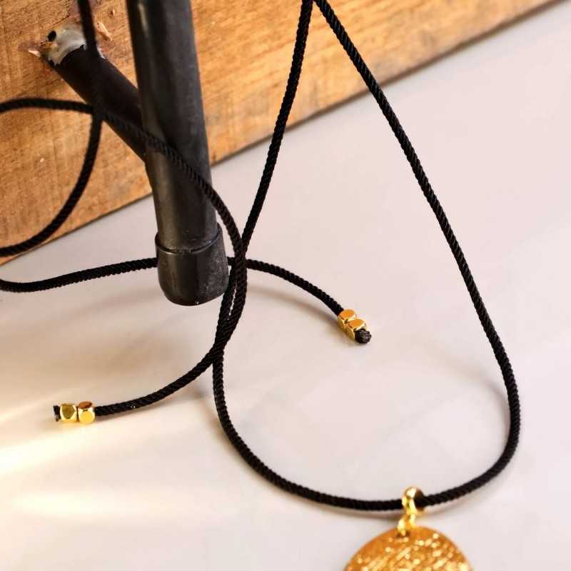 Long necklace with metallic pendant with organic shape