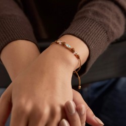 Μακραμέ βραχιόλι σε ροζ χρυσή απόχρωση με μάτι από σμάλτο